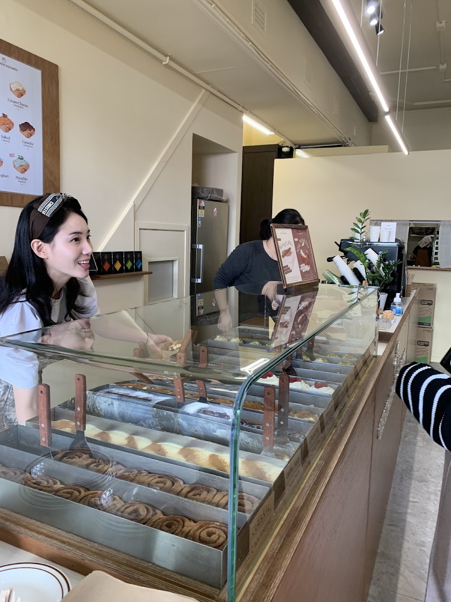 Inside Cinnamon Squared with staff behind the counter